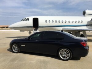 Private jet on the ramp beside an executive car for a Charlotte to New York Teterboro charter flight