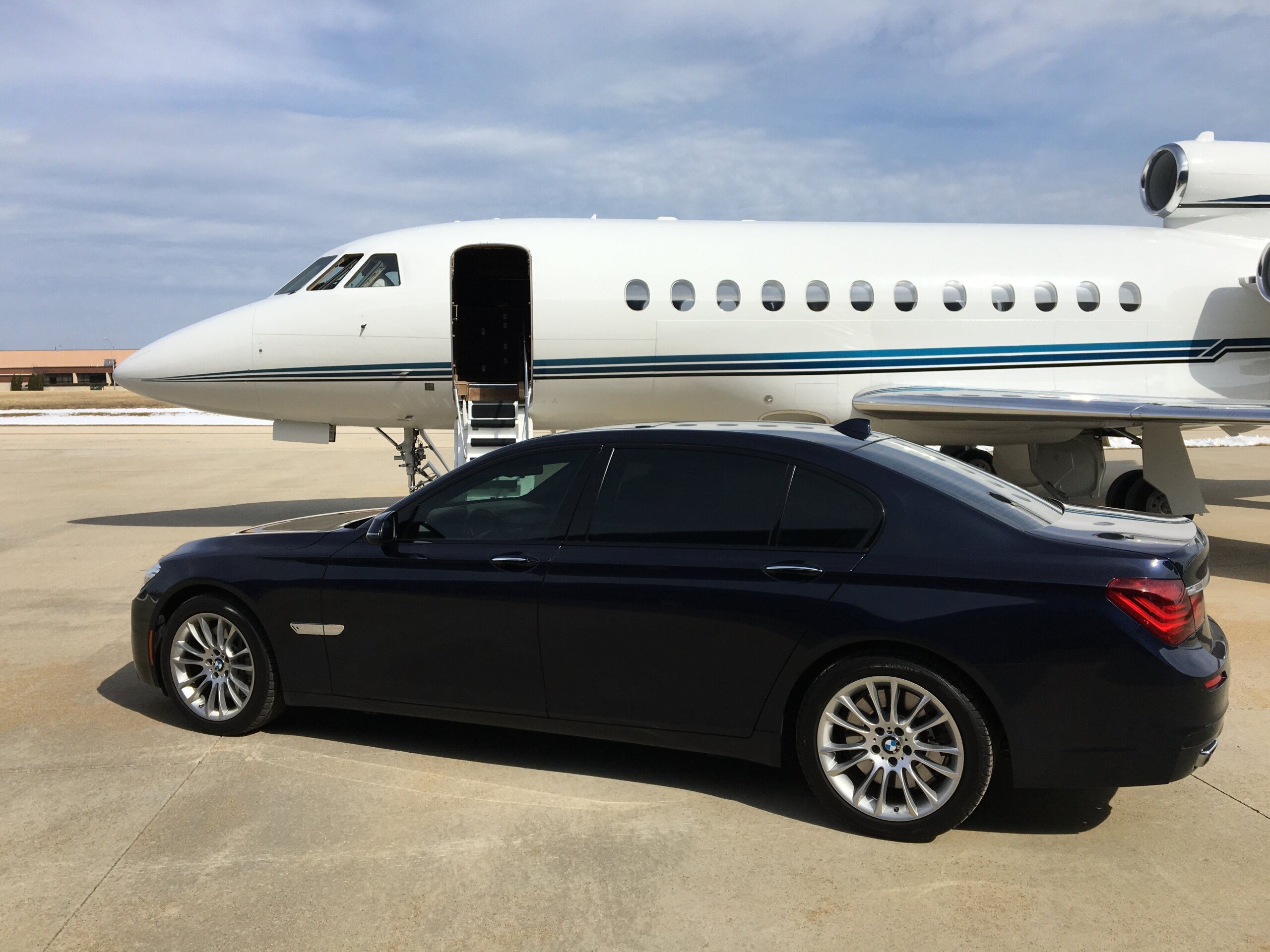 Private jet on the ramp beside an executive car for a Charlotte to New York Teterboro charter flight